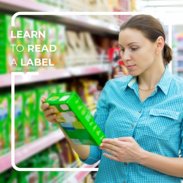 Woman in a blue shirt reading a label in a supermarket